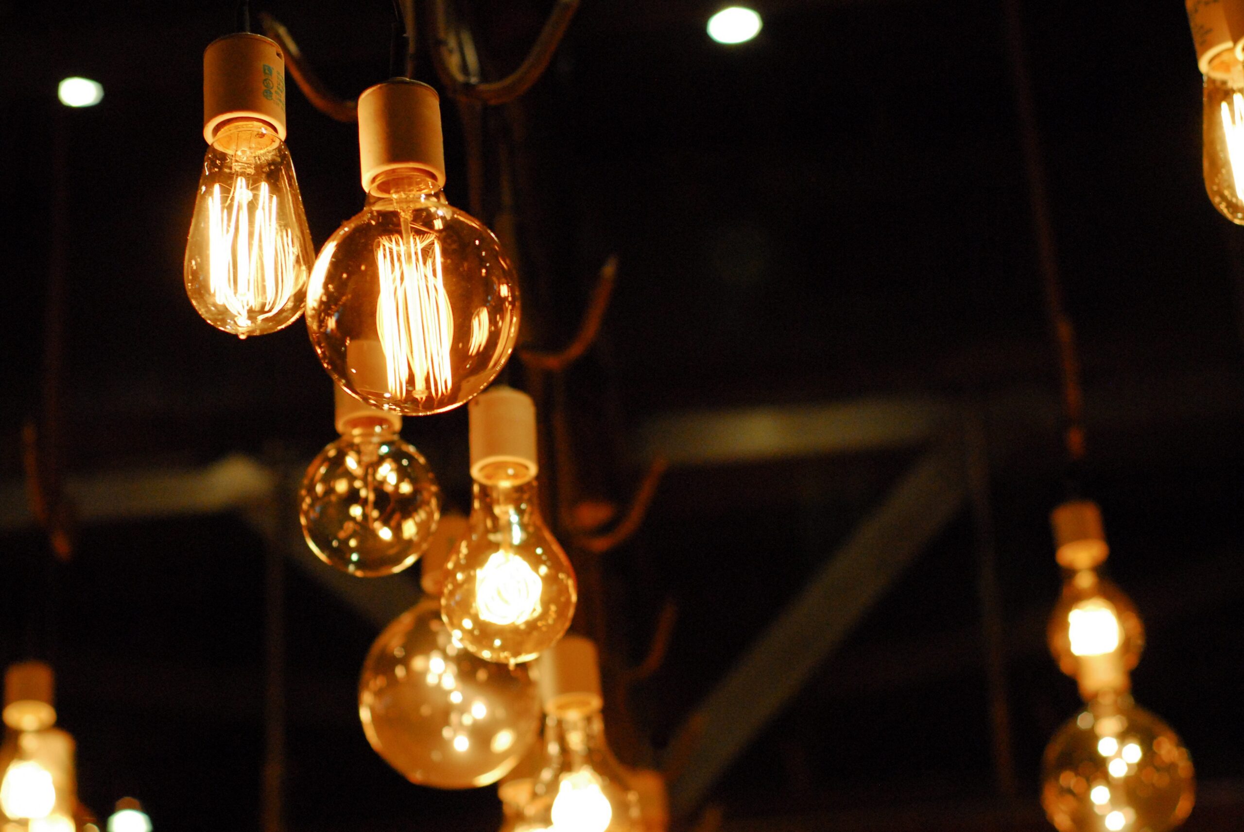 Electrician installing a modern light fixture